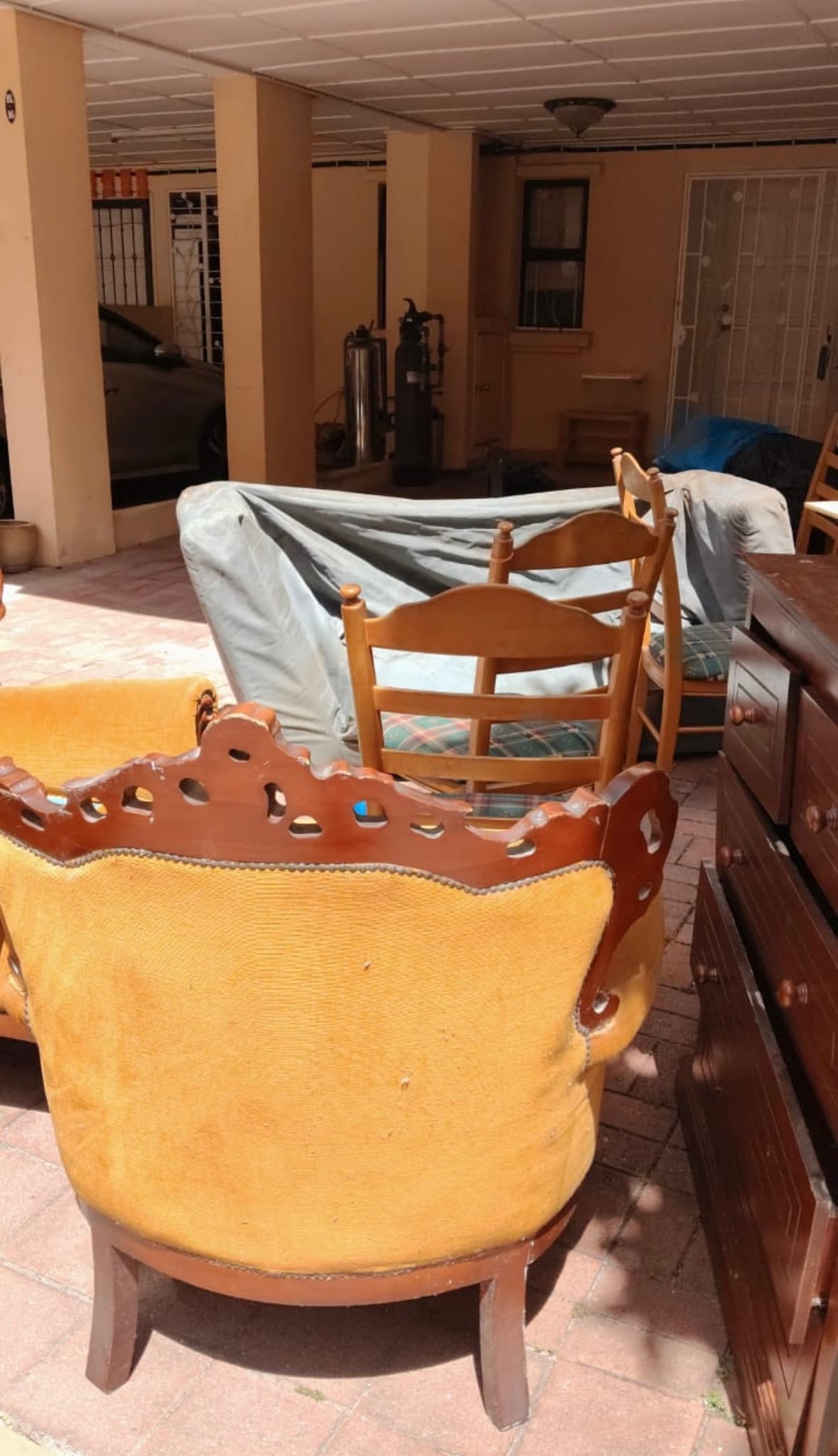Porch filled with old furniture before removal